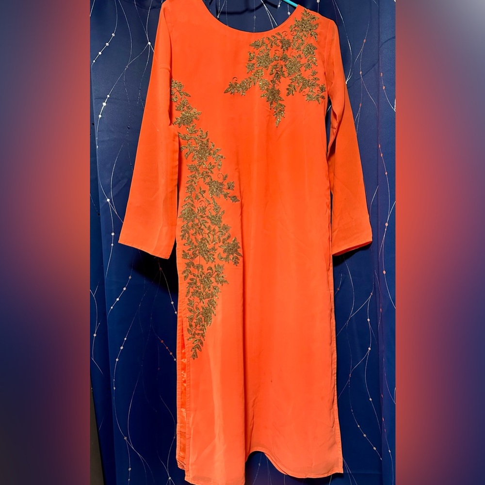 Women's wear: a traditional Indian orange long kurti.